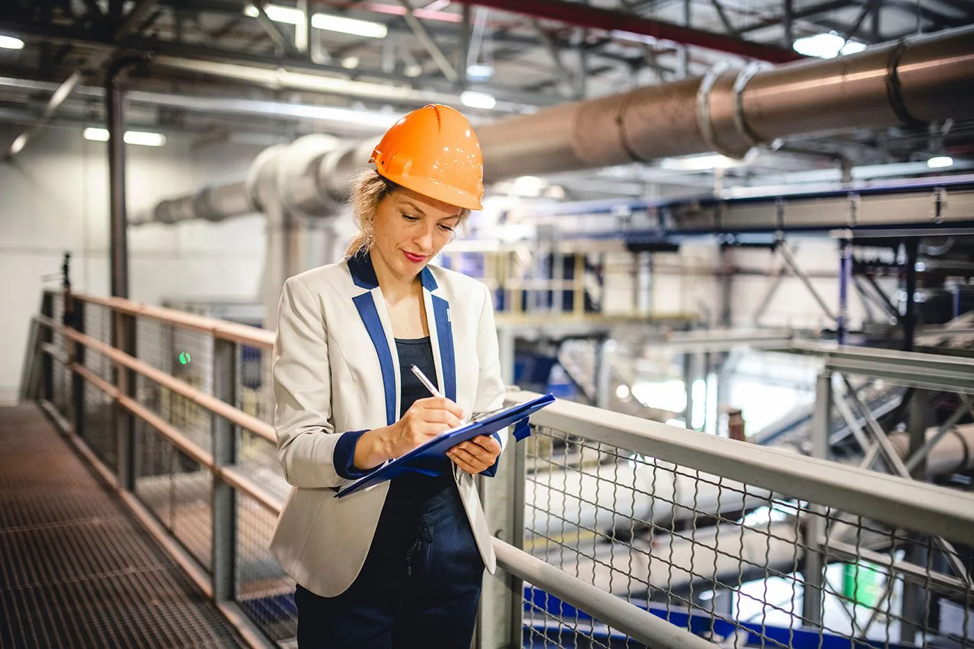 A woman in factory taking notes