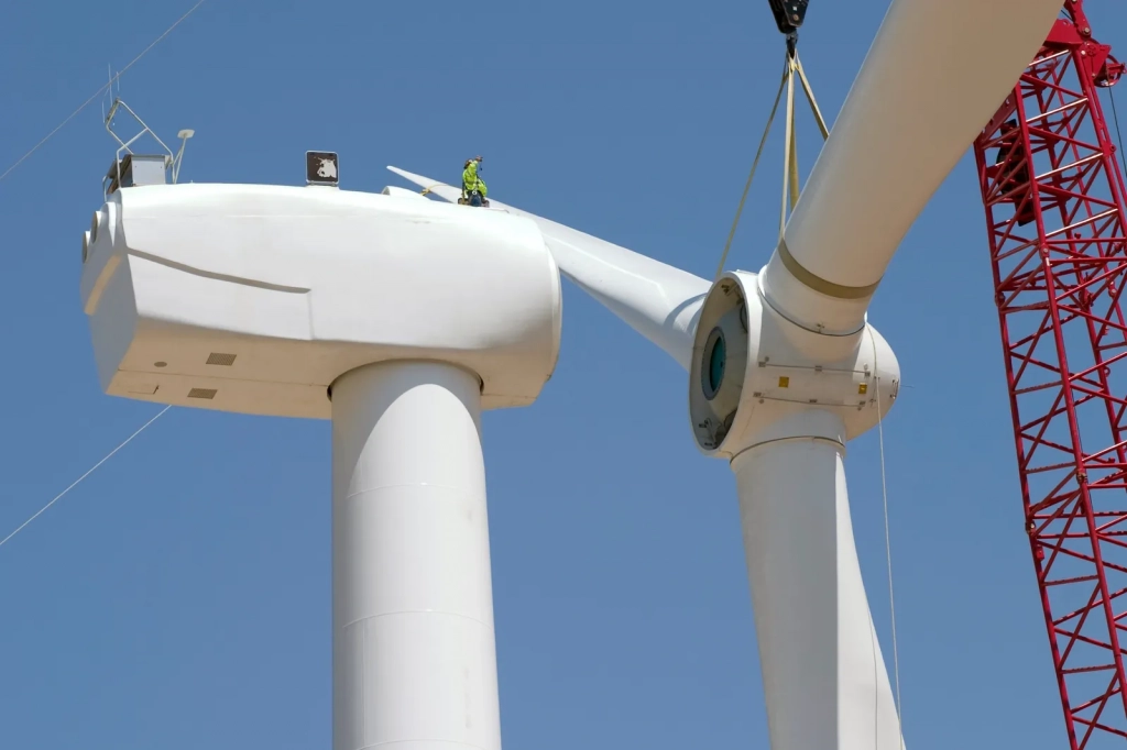 Man on top of wind turbine