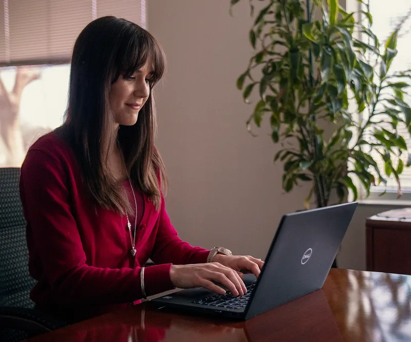 Kate working at her laptop.