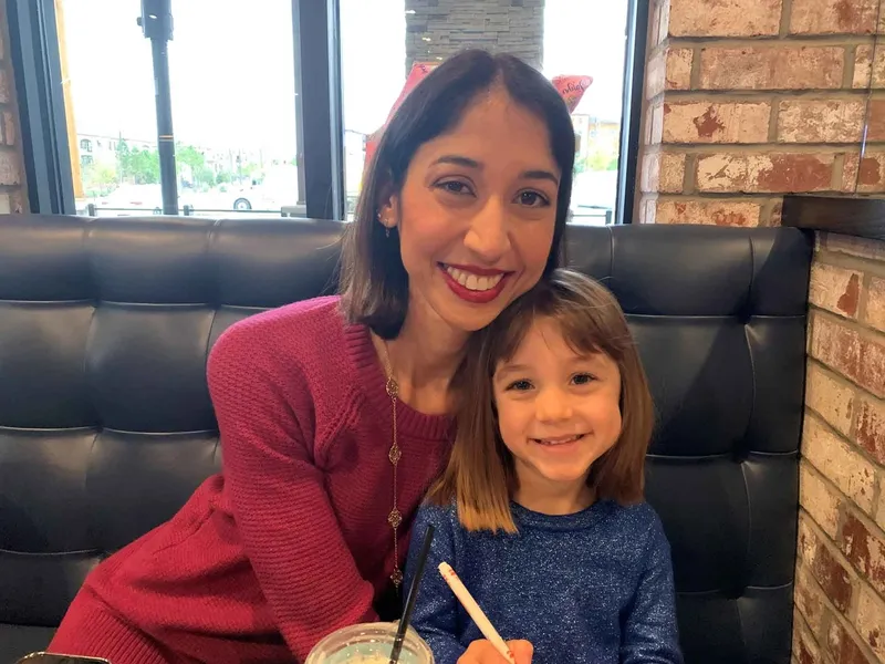 Natalie smiling with her daughter. 