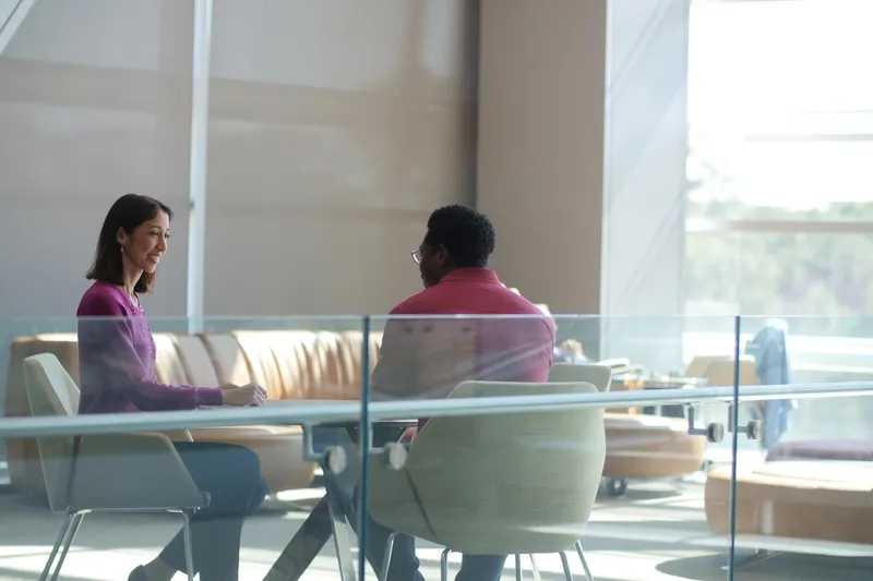 Natalie having a conversation with someone at a table. 