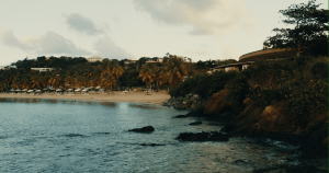 water and cliffs with a beach in the distance