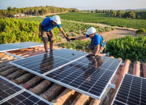 workers installing solar panels.