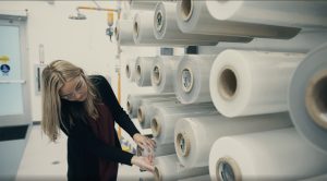 Jessica inspects stacks of plastic wrap