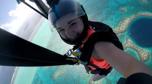 Jessica skydiving over an island