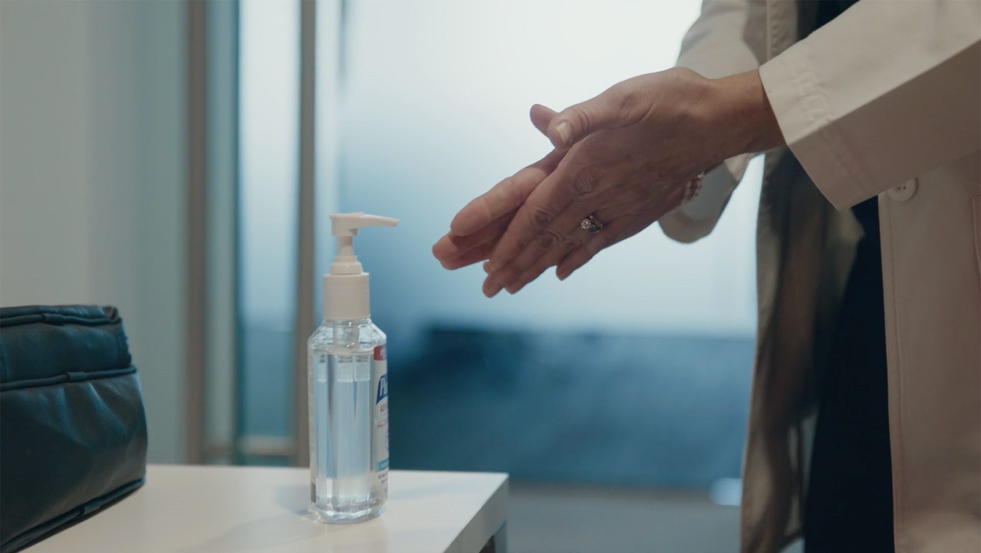 Nurse using hand sanitizer.