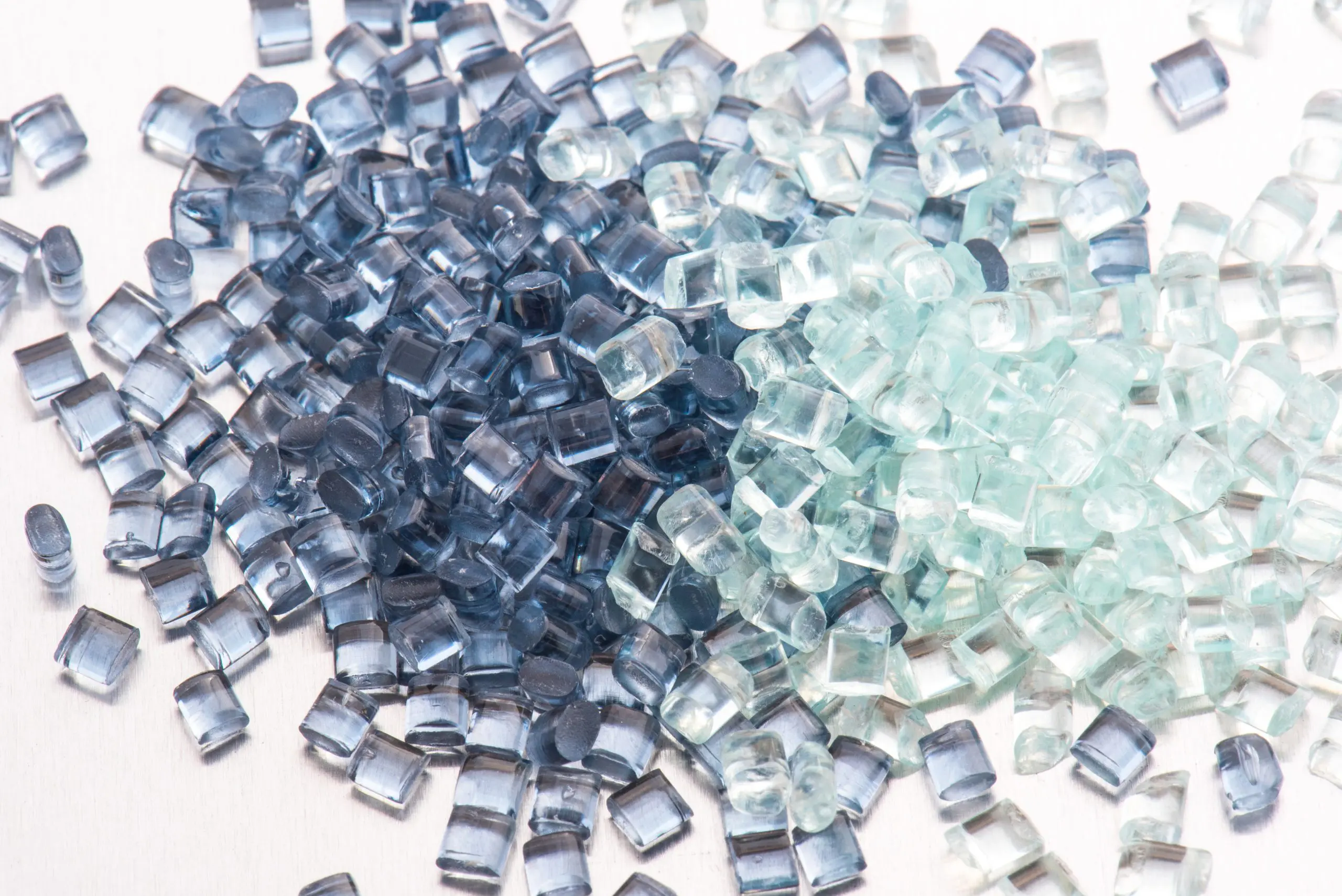 two different polymer plastic granulates on white background