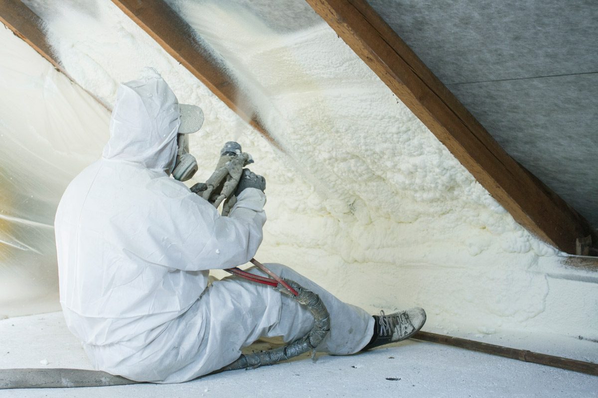 man installing spray foam