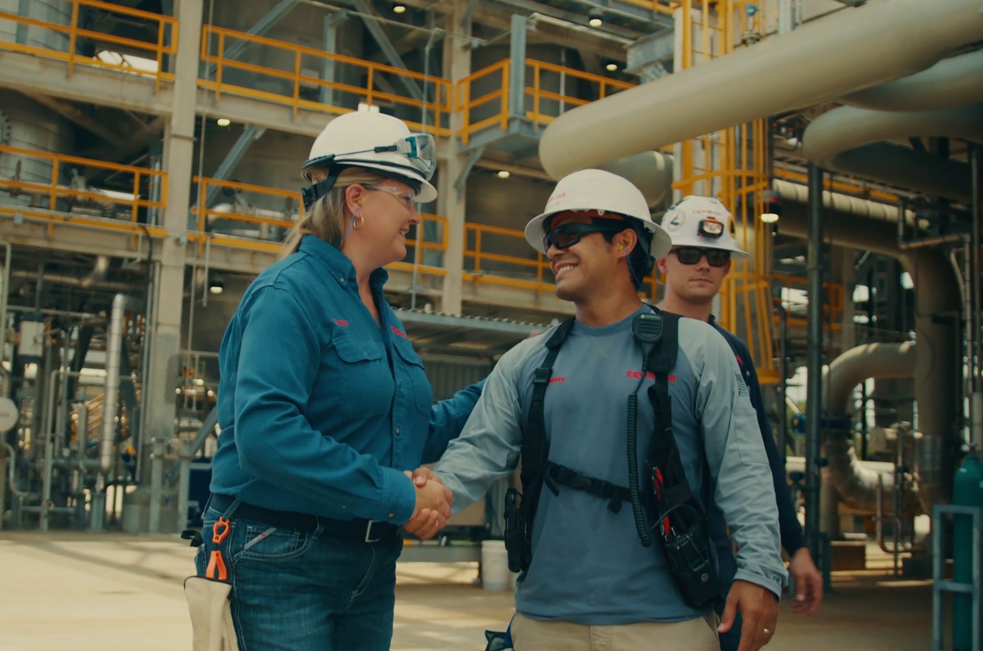 Pam from ExxonMobil shaking hands with coworker.