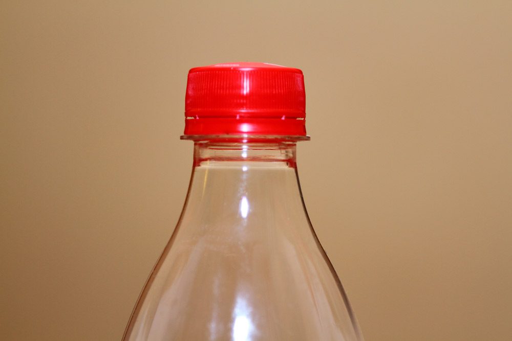 Plastic bottle with red cap.