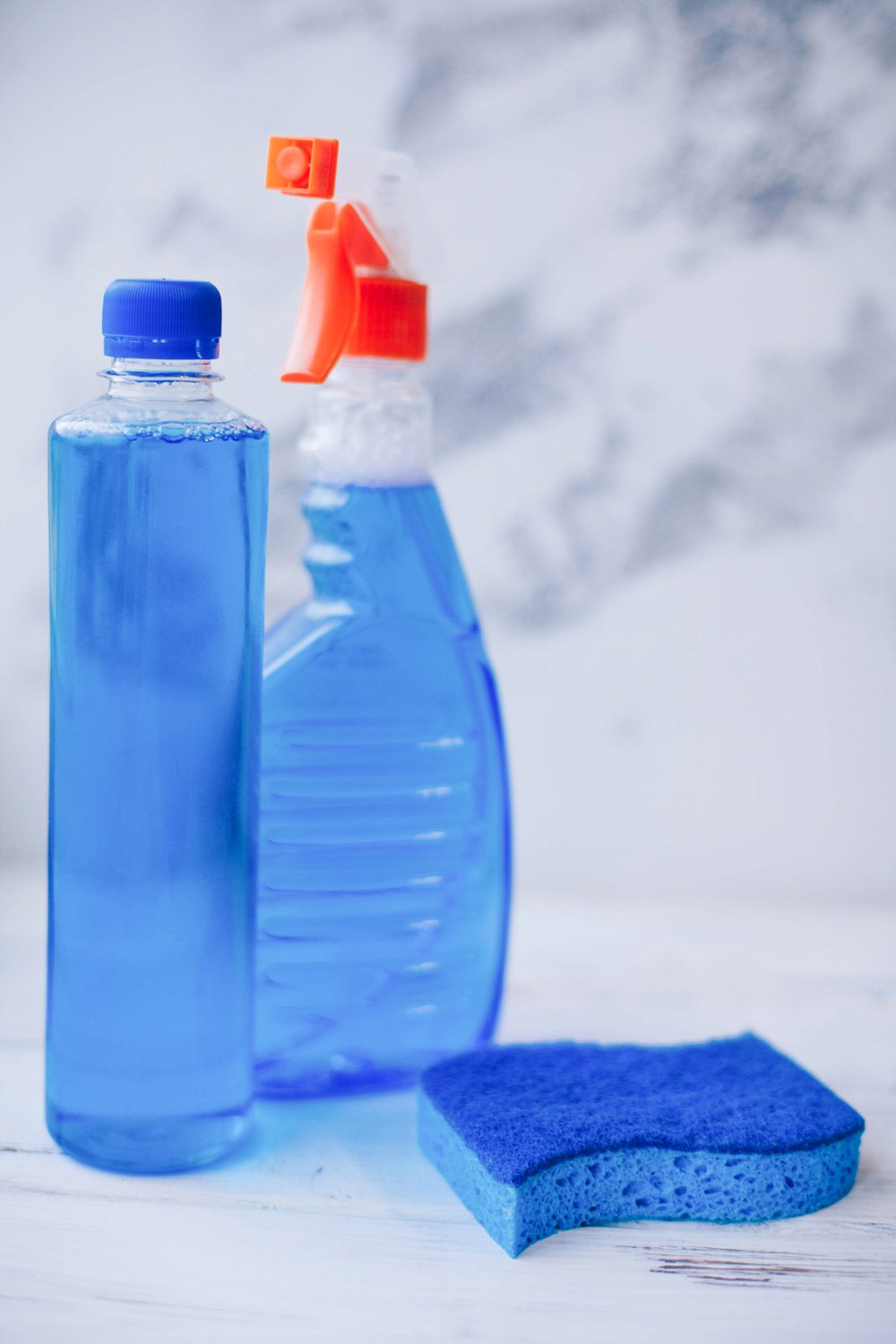 Bottles with blue cleaning detergent