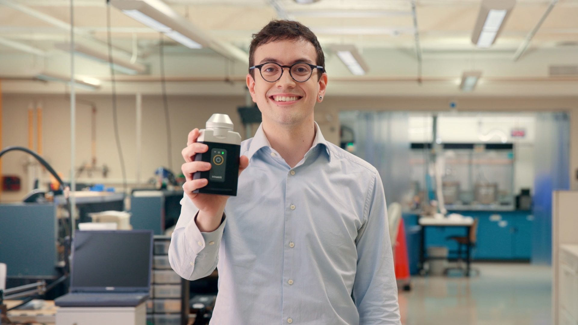 Brian holds up a portable device