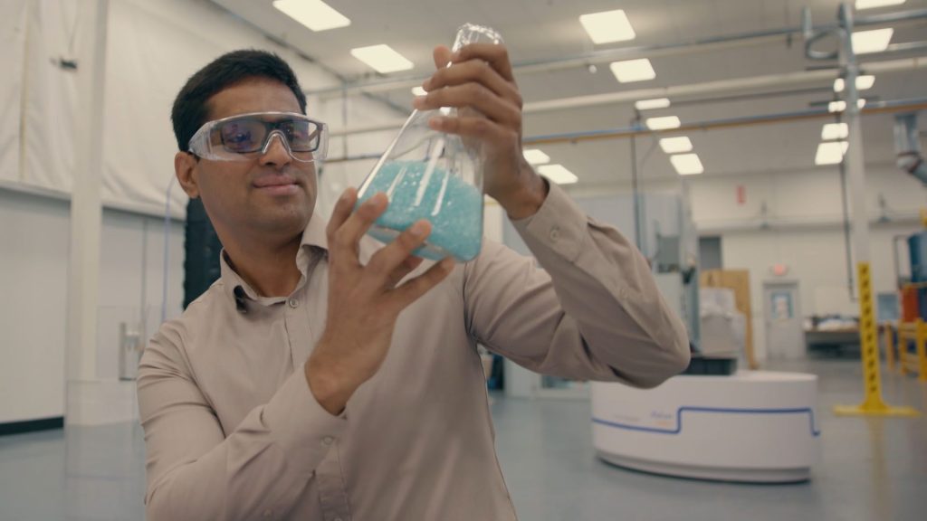 Dinesh inspects a beaker