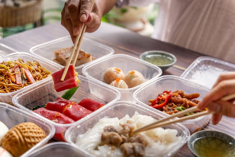 Dinner spread showing a variety of food items in plastic delivery containers