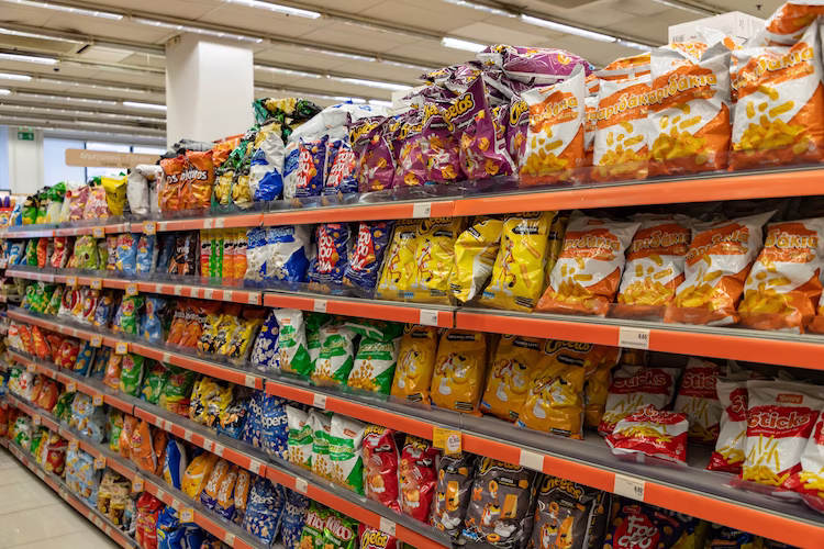 Grocery store aisle displaying a large selection of potato chips.