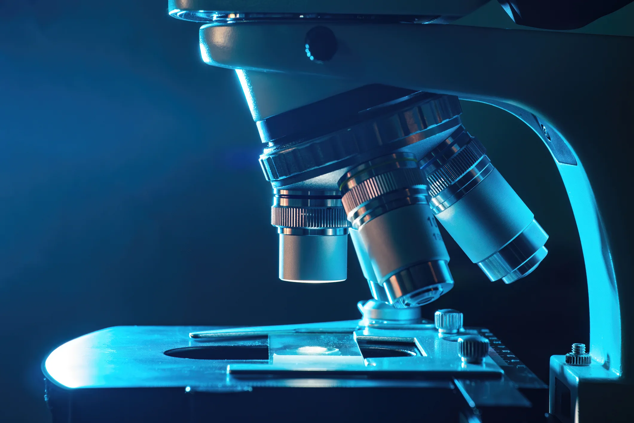 Microscope in laboratory at night. Microbiology and research concept.