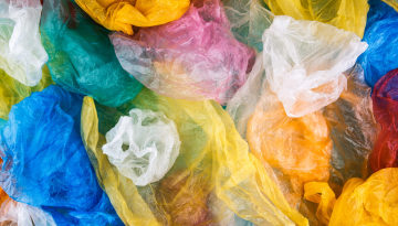 Multicolored plastic bags texture background. Polyethylene environmental pollution concept.